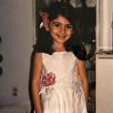 Layla as a child, waving